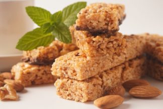 Picture of a protein flapjack with nuts and a leaf