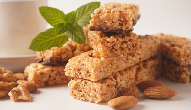 Picture of a protein flapjack with nuts and a leaf