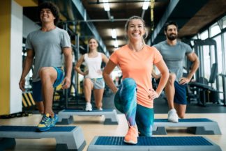 smiling people exercising at the gym