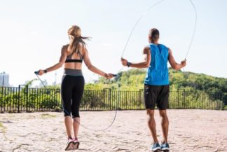A man and woman skipping rope as a form of anaerobic exercise